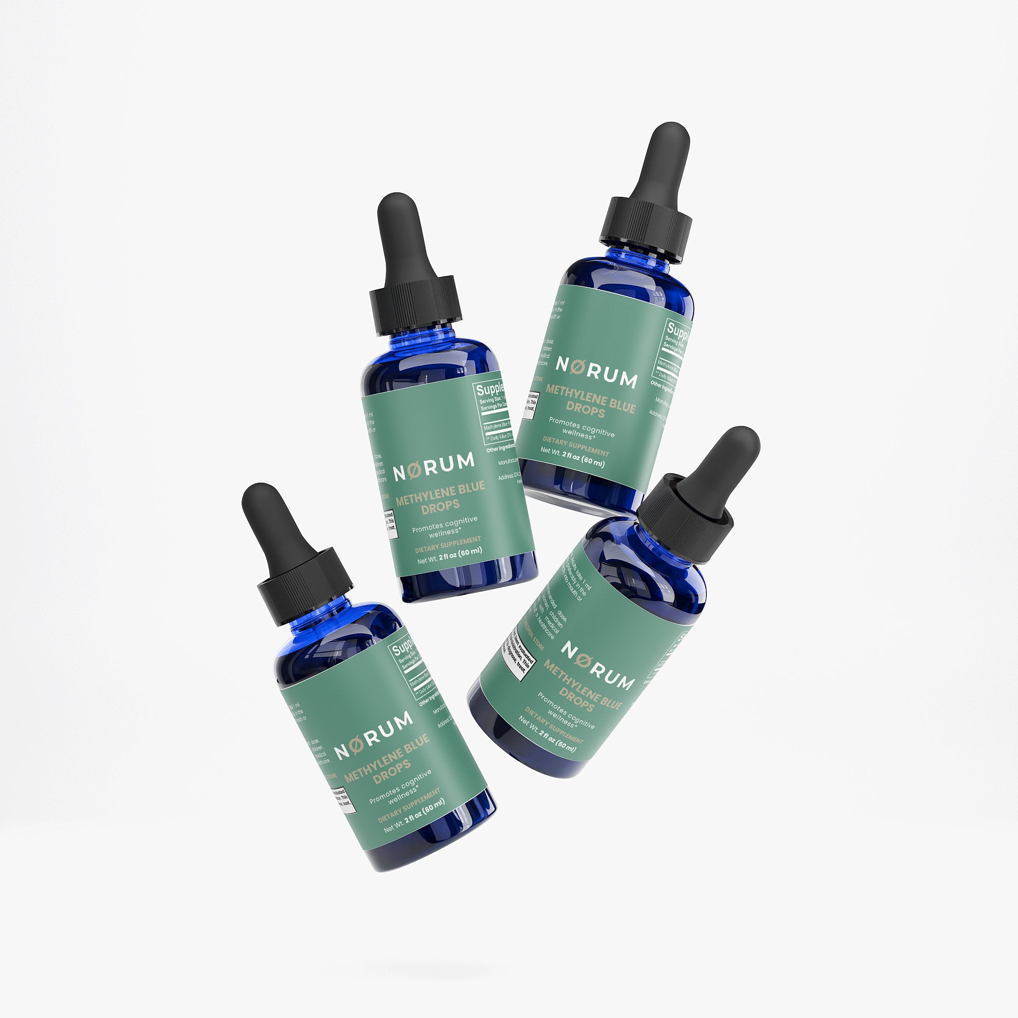 Four blue dropper bottles labeled Methylene Blue Drops dietary supplement on white background