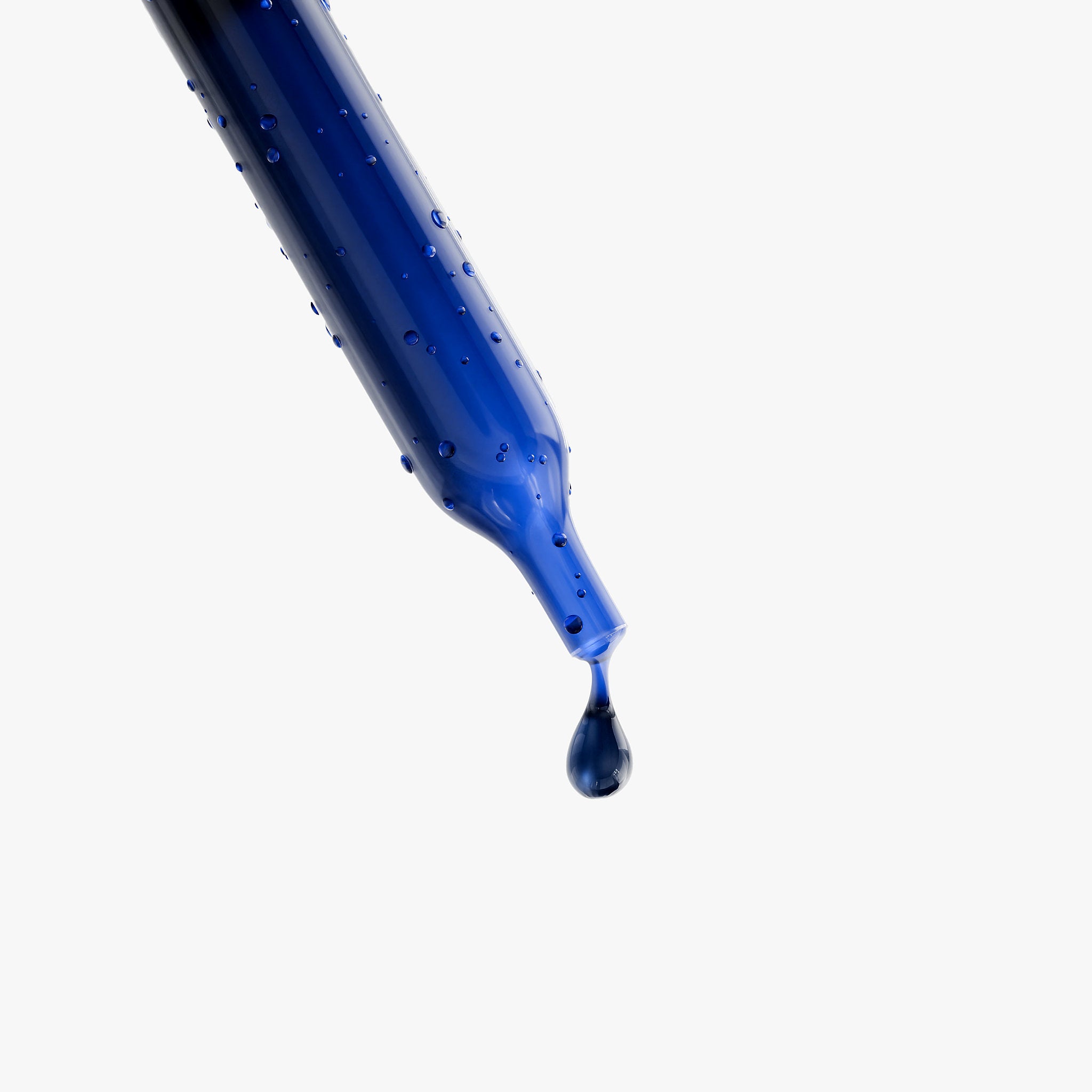 Blue glass dropper with a liquid droplet, isolated on white background, supplement concept