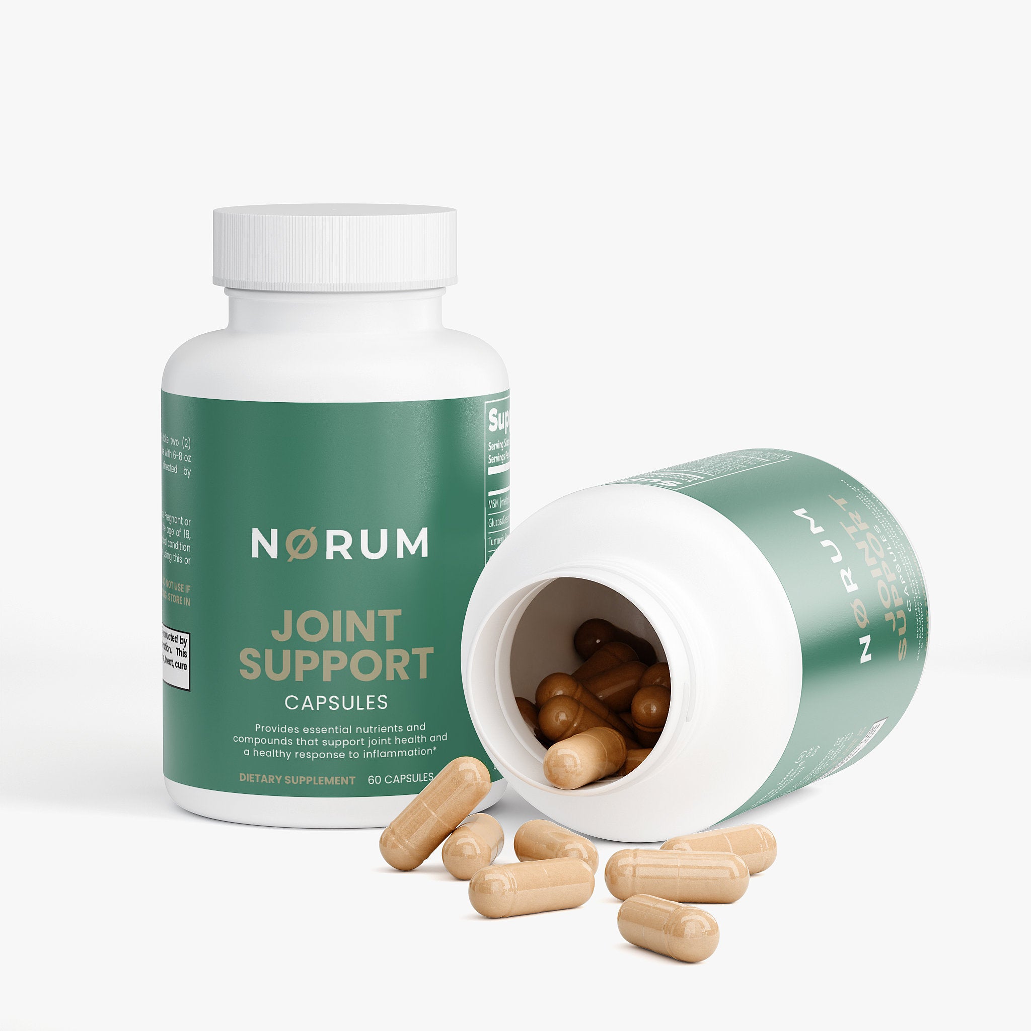 Joint support supplement capsules in green bottles with some capsules spilled on white background