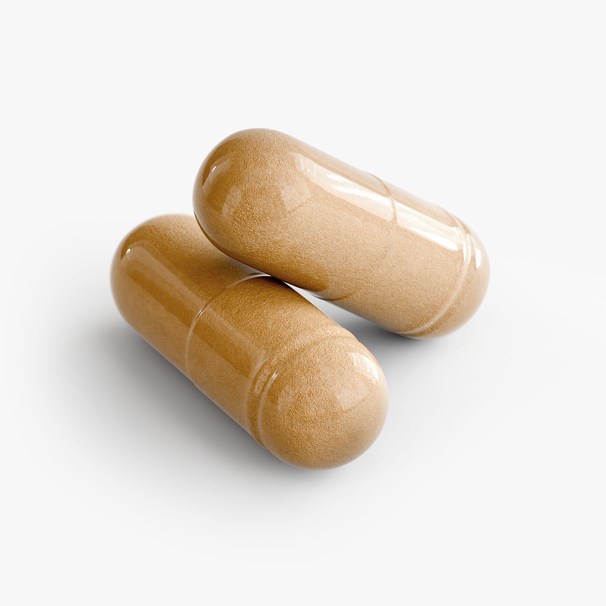Close-up of two beige supplement capsules on a white background