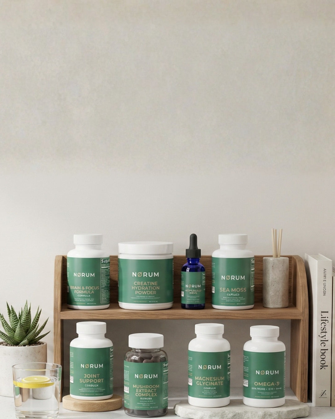 Assorted green-labeled supplement bottles on a wooden shelf with a plant and glass of water.