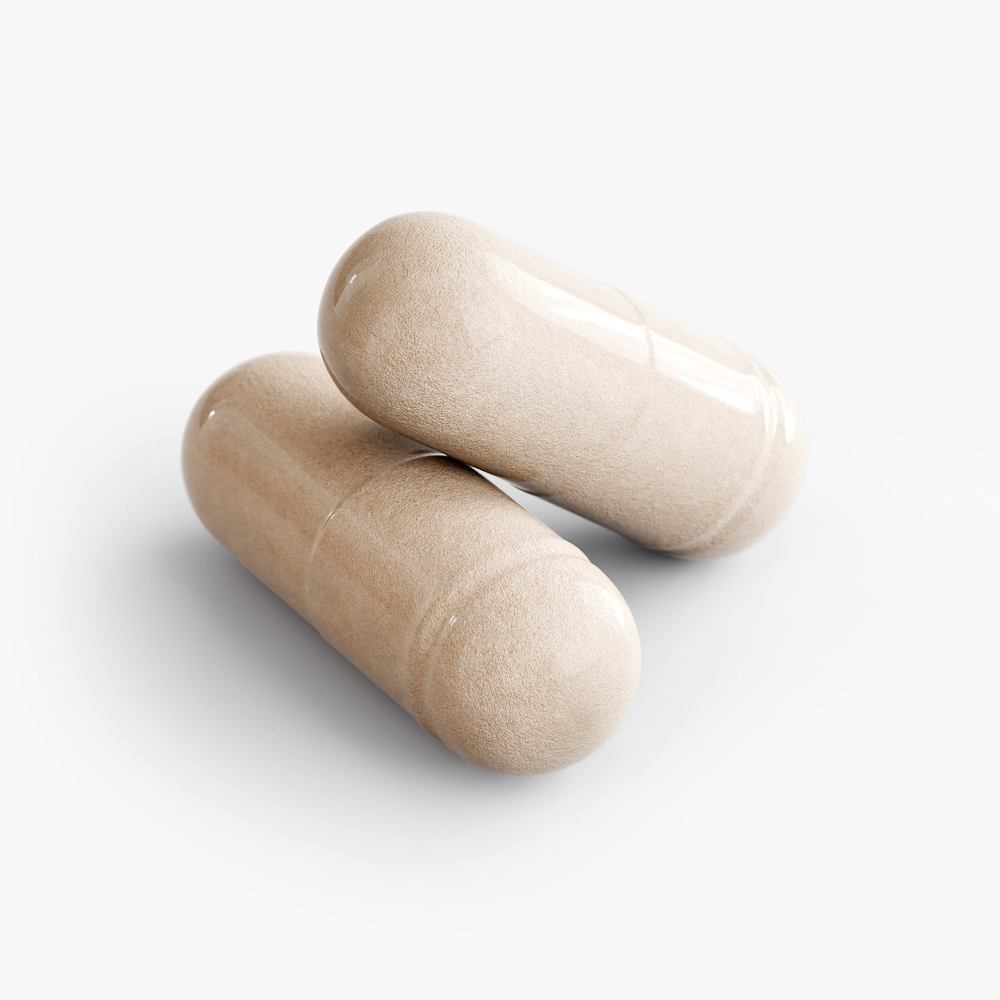 Two beige supplement capsules on a clean white background