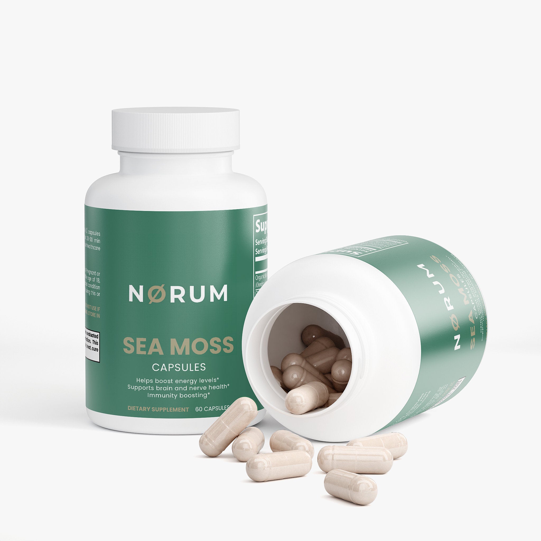Sea moss capsules dietary supplement bottles with capsules spilling on white background
