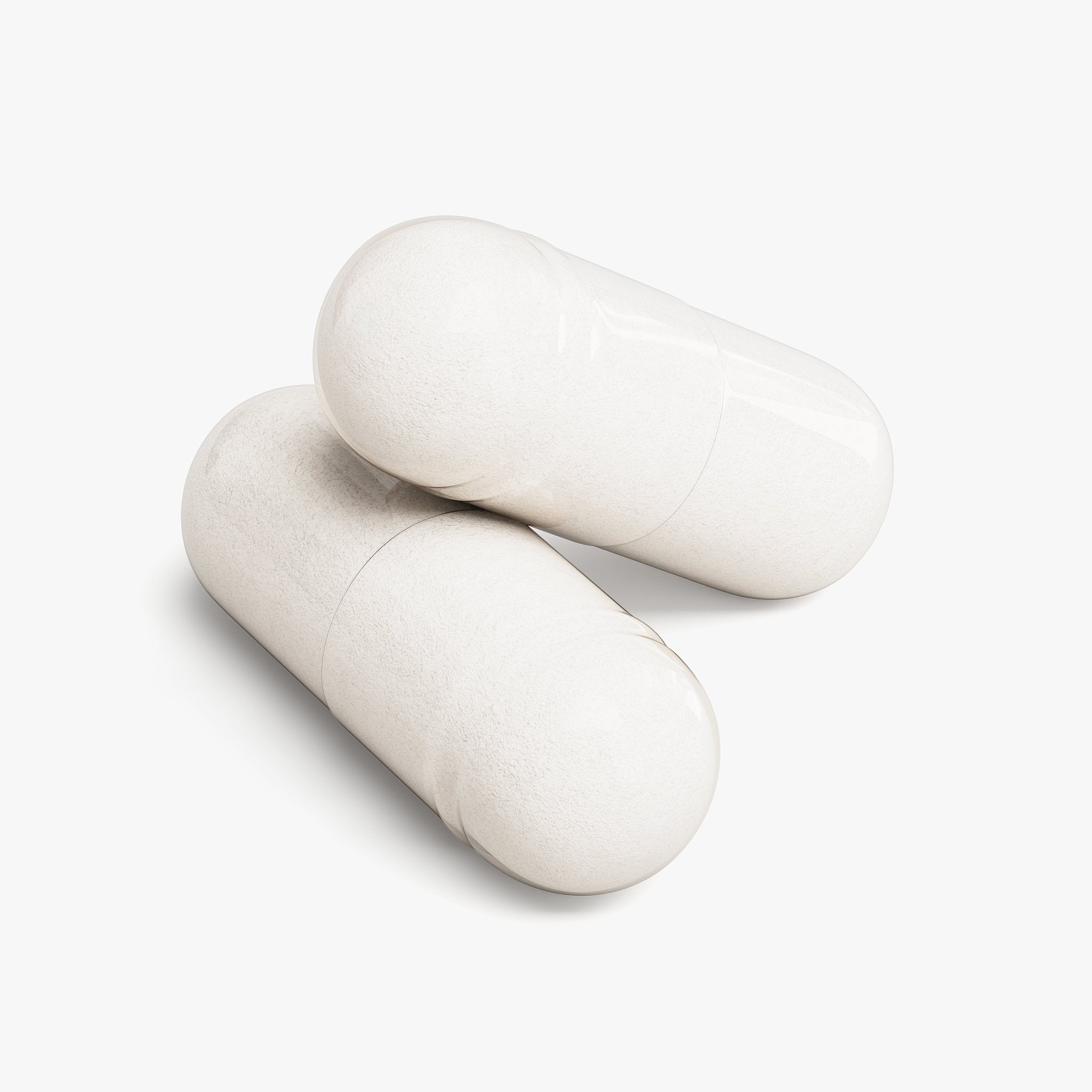 Two white supplement capsules on a clean white background