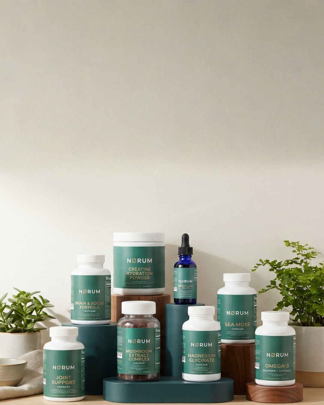 Assorted Nørum supplements and vitamins in green containers on a display with plants